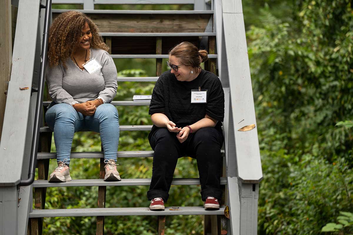 Two women sitting outside on staircase