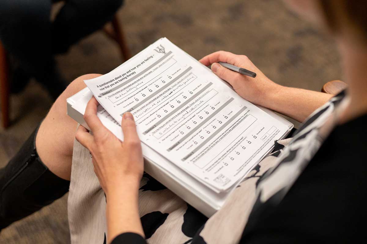 Person holding papers in lap