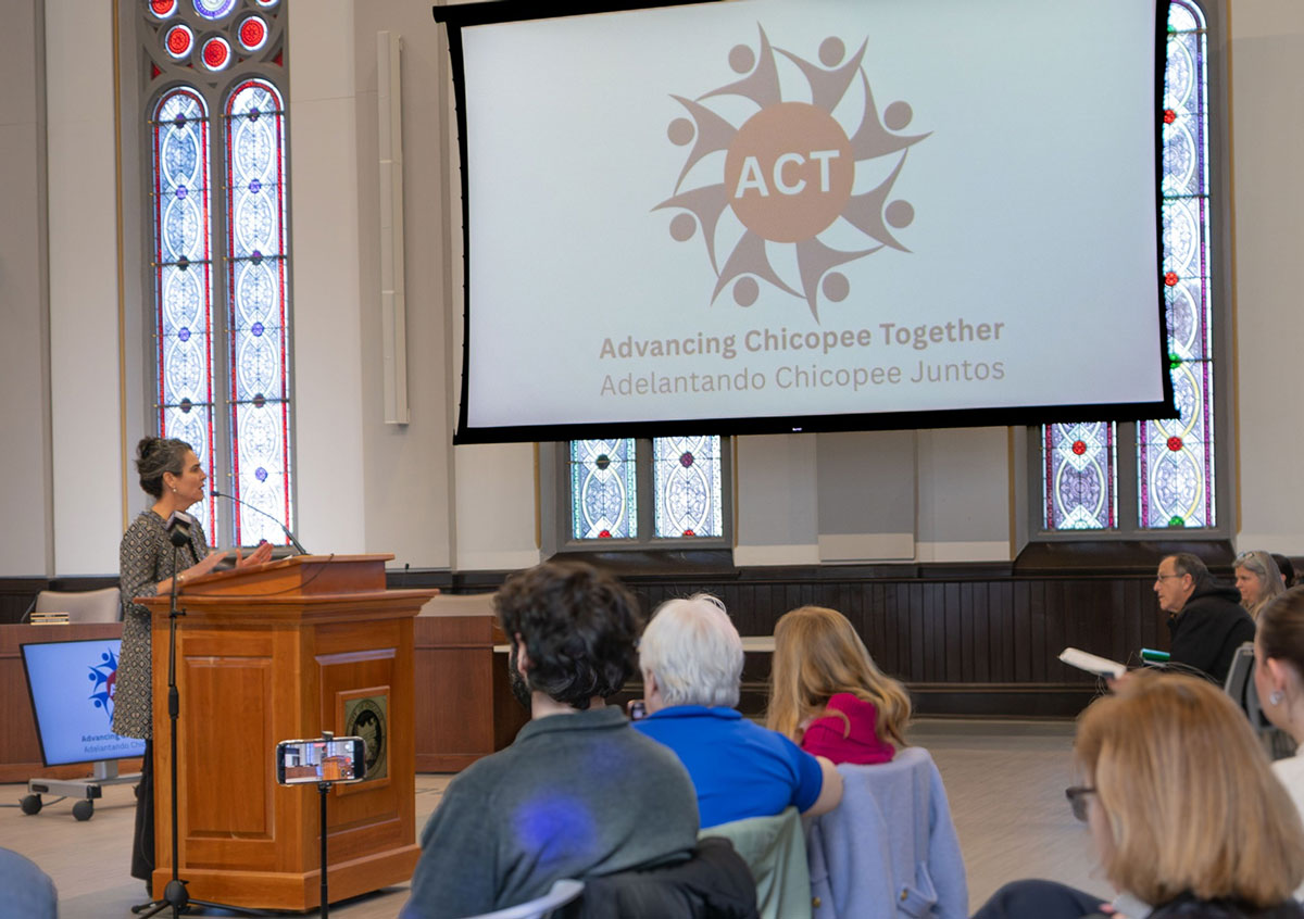 Jessica Collins, Executive Director of the Public Health Institute of Western Massachusetts welcomes attendees at the launch event for Advancing Chicopee Together / Adelantando Chicopee Juntos (ACT).